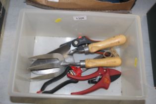 A small quantity of gardening tools to include tro