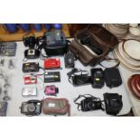 A collection of various cameras including Pentax,