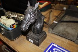 A decorative bronzed horse head bust