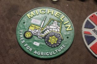 A painted circular cast iron sign for 'Michelin Ty