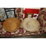 A large rustic style wooden bowl and another simil