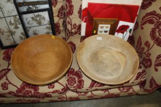 A large rustic style wooden bowl and another simil