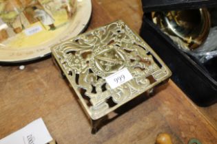 An antique brass hearth stand decorated with British Coat of Arms Order of the Garter, Lion and
