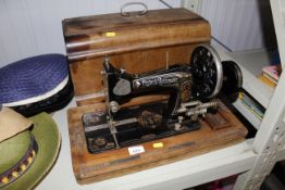 A Frister and Rossmann sewing machine in walnut ca