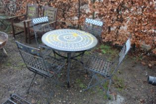 A metal framed tiled top garden table and a set o