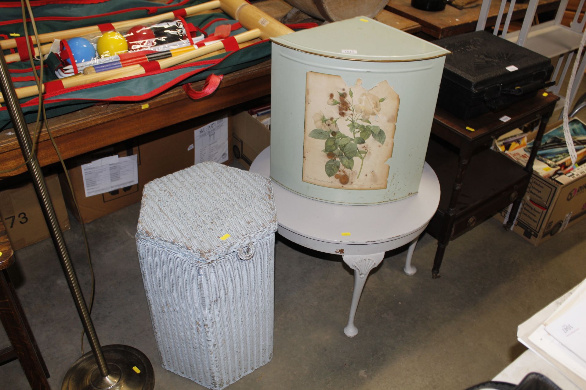 A decorated tin corner laundry basket; a Loom line