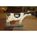 A painted cast iron door stop in the form of a cow