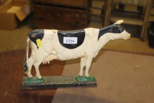 A painted cast iron door stop in the form of a cow