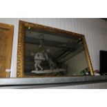 A decorative gilt frame wall mirror with etched de