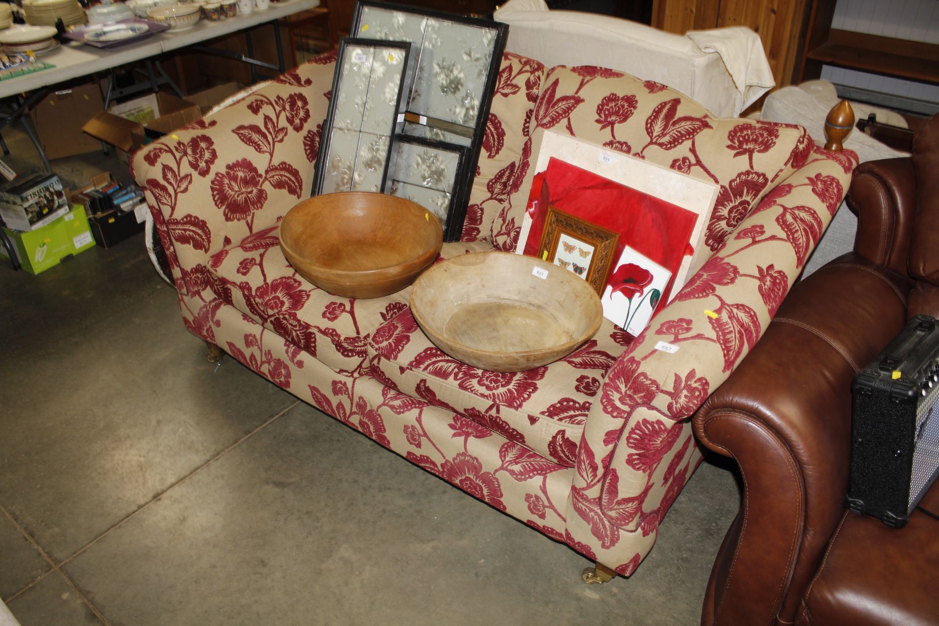 A floral upholstered two seater sofa