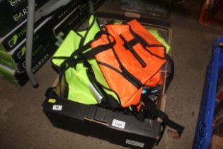 A box containing various flotation life jackets