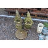 A pair of concrete wizard ornaments and a 1956 Farthing concrete plaque