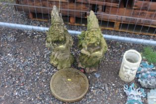 A pair of concrete wizard ornaments and a 1956 Farthing concrete plaque