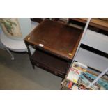 A mahogany two tier side table with pull out slide and drawer