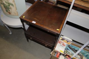 A mahogany two tier side table with pull out slide and drawer