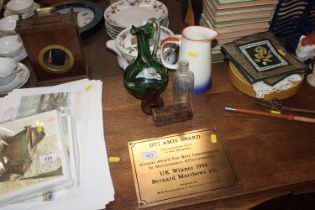 A Bernard Matthews 1994 award plaque; a green glas