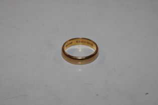 A 22ct gold wedding band, approx. total weight 7.5