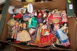 A box of various souvenir dolls