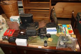 A quantity of various cameras and binoculars to in