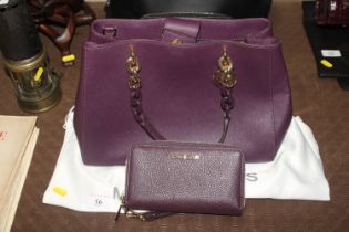 A Ladies Michael Kors purple handbag and matching