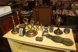 A quantity of brass bell weights, candlesticks, ta