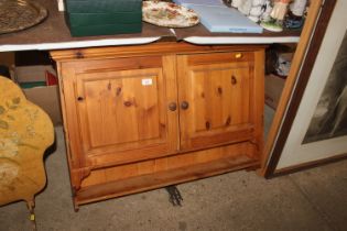 A pine hanging two door cupboard