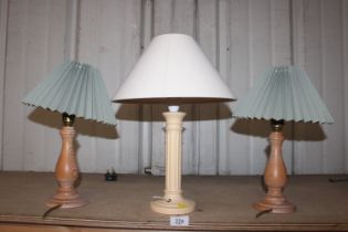 A pair of turned table lamps and one other