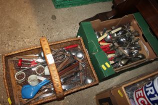 A box and a wicker tray of various flatware