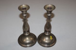 A pair of white metal candlesticks, approx. total