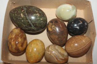 A box of polished stone and onyx artificial eggs