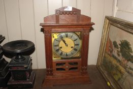 An oak cased two hole mantel clock