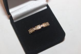 A 925 silver gilt eternity ring set with baguette cut white stones