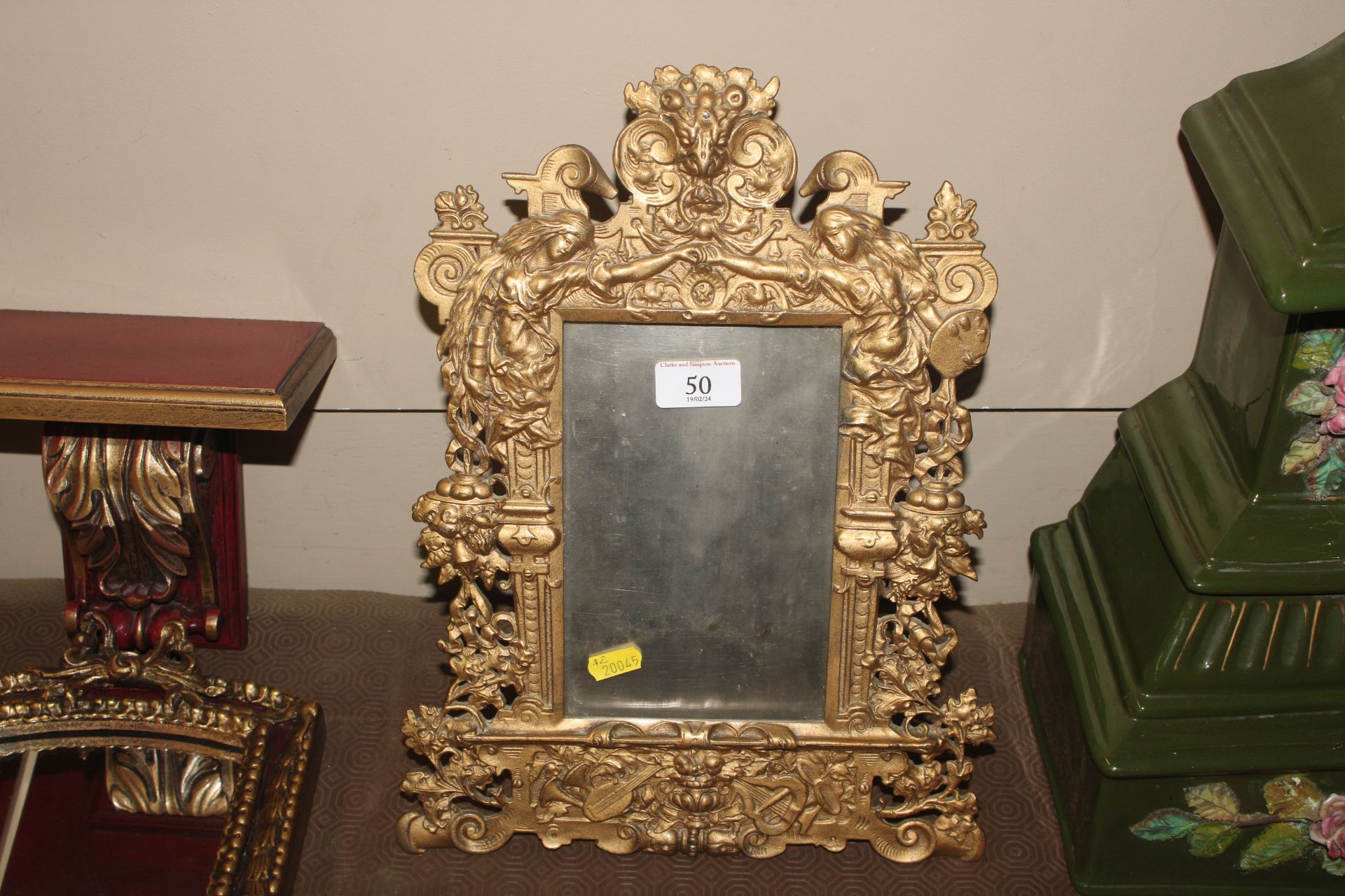 A gilt metal easel photo frame