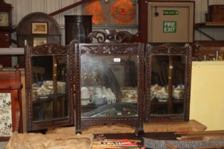 A carved oak triptych mirror