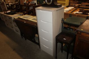 A modern wood effect chest fitted five drawers