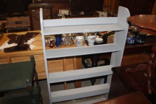 A grey painted five tier shelving unit