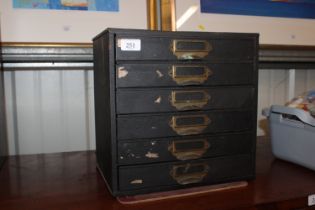 A table top metal chest fitted six drawers