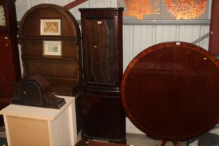 A mahogany and glazed corner cabinet