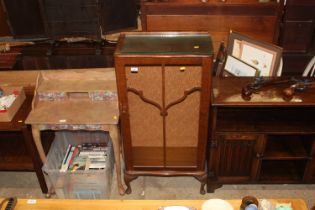 A walnut glazed side cabinet raised on squat cabri