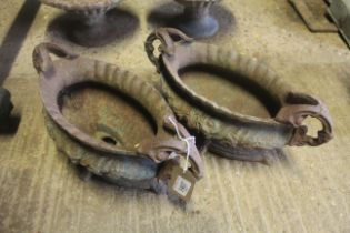 A pair of oval cast iron ornate twin handled garden urns