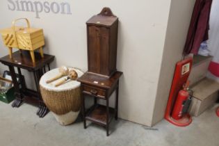 A small oak side table with drawer and a tall cand