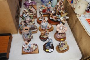 A quantity of china figures set on wooden plinths