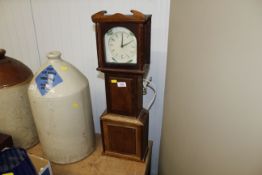 A small replica Grandfather clock containing a Smi