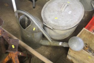 A galvanised watering can with rose