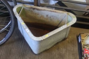 A galvanised corner feed trough