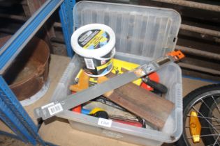 A box containing various tools to include hand saw