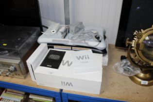 A Nintendo Wii board, a Nintendo Wii console with