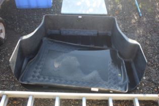 A Subaru Legacy boot liner and one other