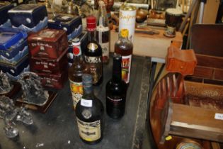 A box of Martell cognac and various other bottles