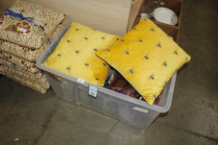 A box containing two embroidered bumblebee cushion